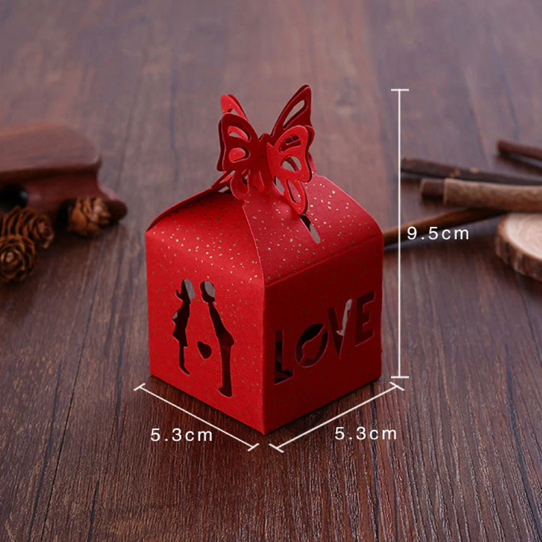 May include: Red paper favor box with a butterfly design and the word "LOVE" cut out. The box measures 5.3 inches by 5.3 inches by 9.5 inches.
