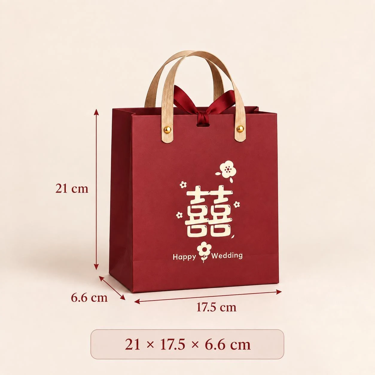 May include: A deep red paper gift bag with light brown handles, a dark red ribbon bow, and gold-colored rivets. The front features a white double happiness symbol, floral icons, and the text Happy Wedding. Dimensions are 21 cm by 17.5 cm by 6.6 cm.