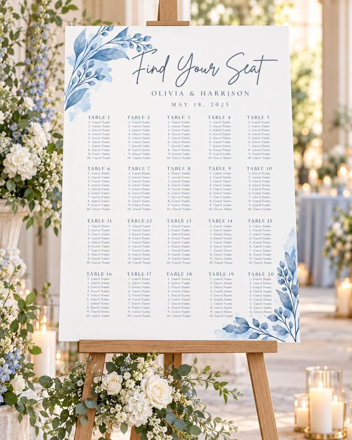 May include: A white wedding seating chart sign on a wooden easel featuring blue watercolor botanical illustrations. The text reads Find Your Seat, Olivia & Harrison, May 18, 2025, followed by a grid of twenty tables with ten guest name lines each.