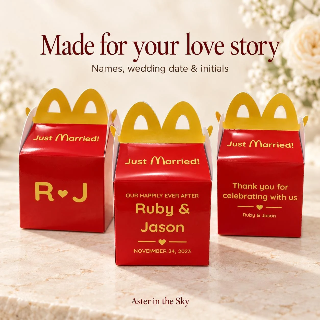 May include: Three red cardboard favor boxes with yellow arched handles. Each box features the text Just Married in yellow. One box displays initials R and J with a heart, another shows Ruby and Jason with a date, and the third says Thank you for celebrating with us.